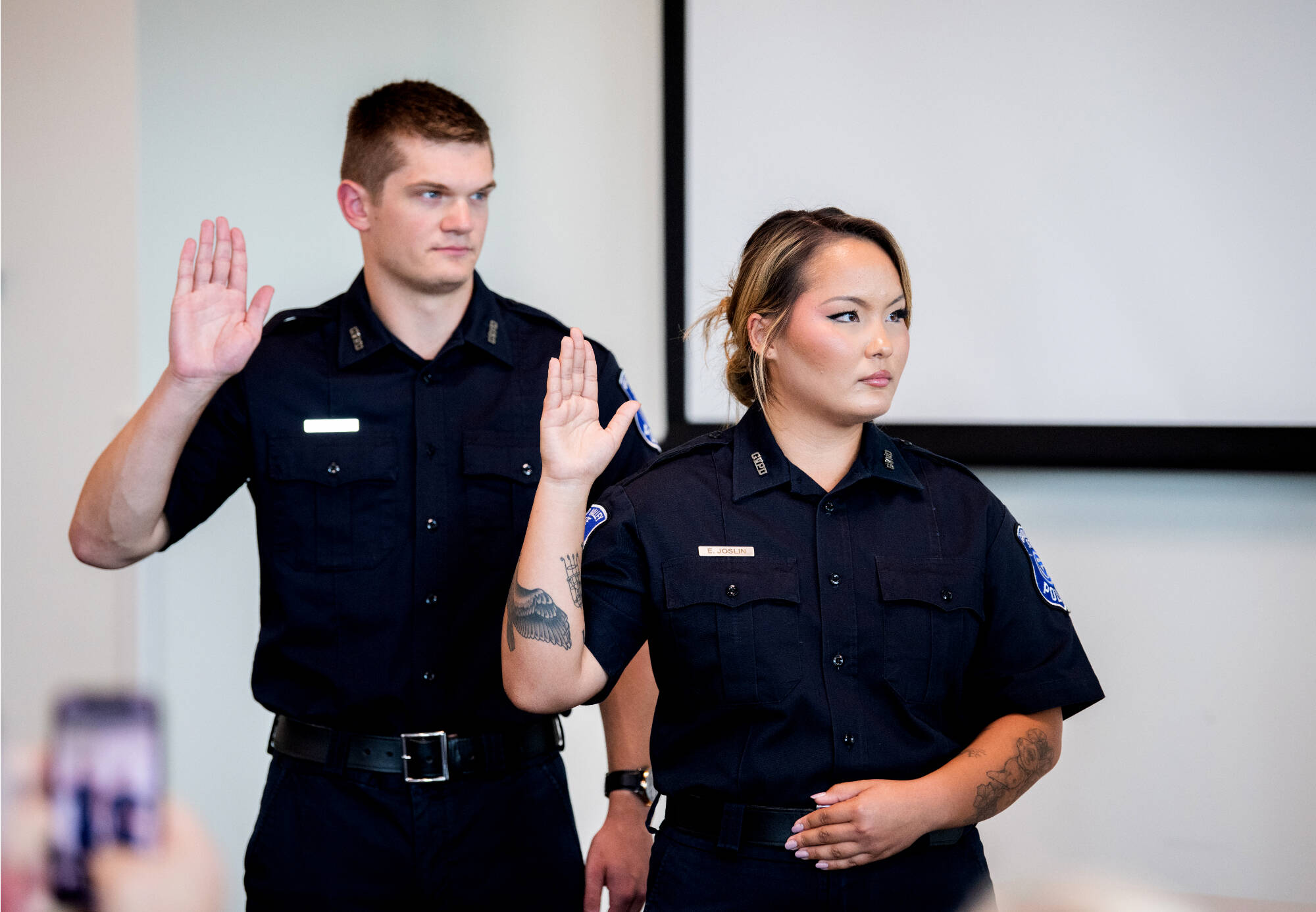 two police officers swearing in, one male, one female